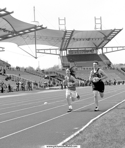 Competitors in one of the 3000m races at the Festival of Athletics, Don Valley Stadium, the athlete on the left is from Hallamshire Harriers