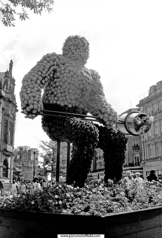 Display for Entente Florale showing Sheffy Stan the Steelman teeming outside the Town Hall