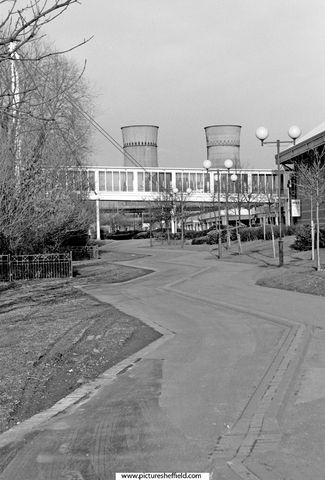 Five Weirs Walk Footpath alongside The Oasis with Footbridge from Transport Interchange to Meadowhall Shopping Centre and Tinsley Cooling Towers in the background