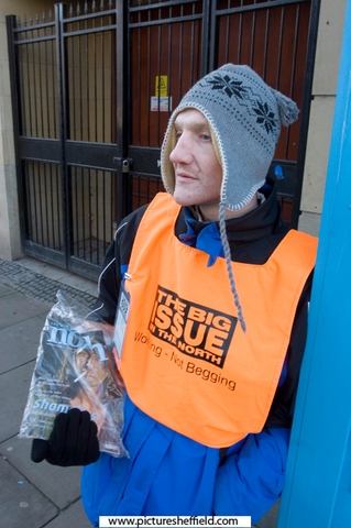 A Big Issue seller outside the front of the Town Hall, Pinstone Street