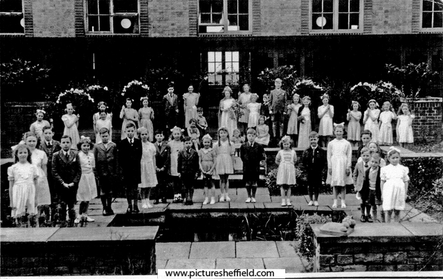 1949 May Queen Crowning Ceremony group photograph taken by the pond in the quadrangle at  Hartley Brook Primary School, Champion Road