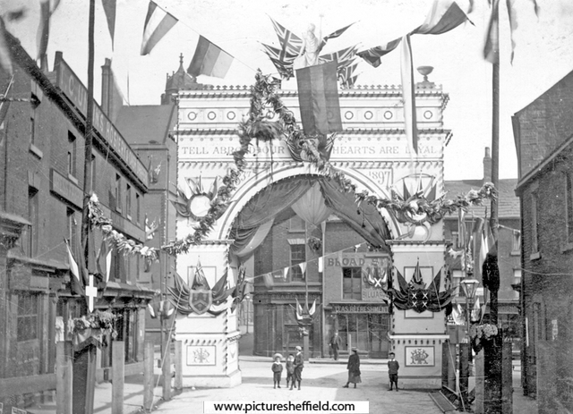 Queen Victoria's visit to Sheffield, decorative arch at junction of Broad Street and South Street, Park, photographed from South Street looking towards Broad Street, premises in background include Broad Street Cafe