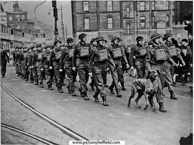 Home Guard anti-aircraft batteries, head a recruiting march through Sheffield.