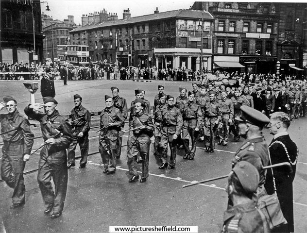 Sir Ronald Adam takes the salute as the Home Guard march past the Town Hall