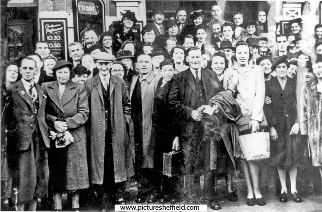 Staff from local cinemas await transport for a days outing, outside the News Theatre, Fitzalan Square