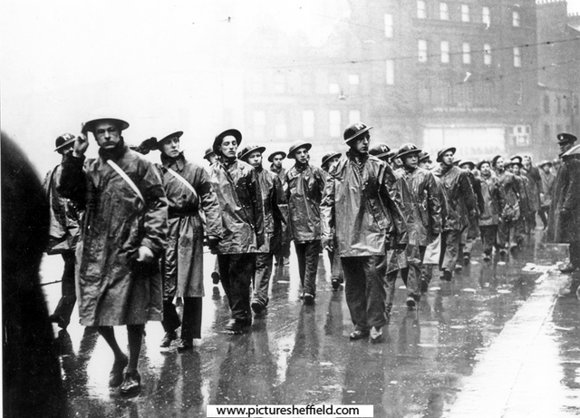 A.R.P. Messengers on parade past the Town Hall during World War II 	