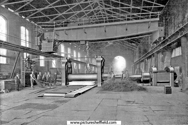 Rolling Armour Plates, possibly English Steel Corporation, River Don Works, Brightside Lane. The material on the right, in front of the three workers, are birch twigs, used for descaling the plates during rolling