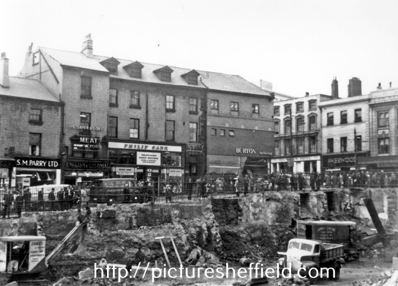 Dixon Lane looking towards Haymarket, during excavations for Woolworth's building (site of Norfolk Market Hall), including Nos. 2/4a Philip Cann, music seller, No. 6 H.C. Sayer and Son Ltd., butchers and No. 8 S.M. Parry, Ltd., fruiterers