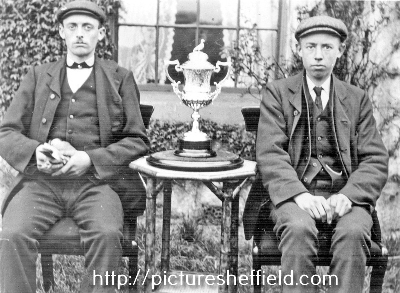 Fred Needham with pigeon (left) and William Needham (right) with Pigeon Racing Cup outside Manor House Farm, No 150, Bawtry Road, Tinsley