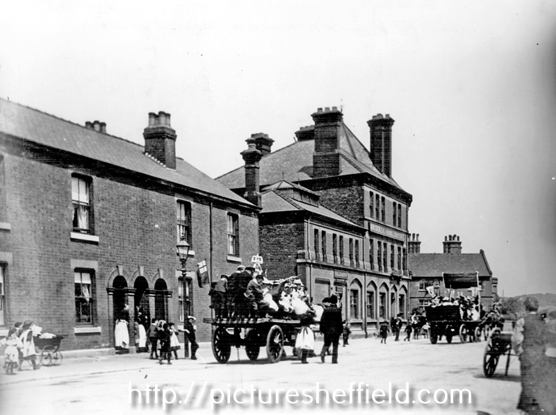 Decorated carts passing through Queen's Road looking towards No 528, Earl of Arundel and Surrey Public House