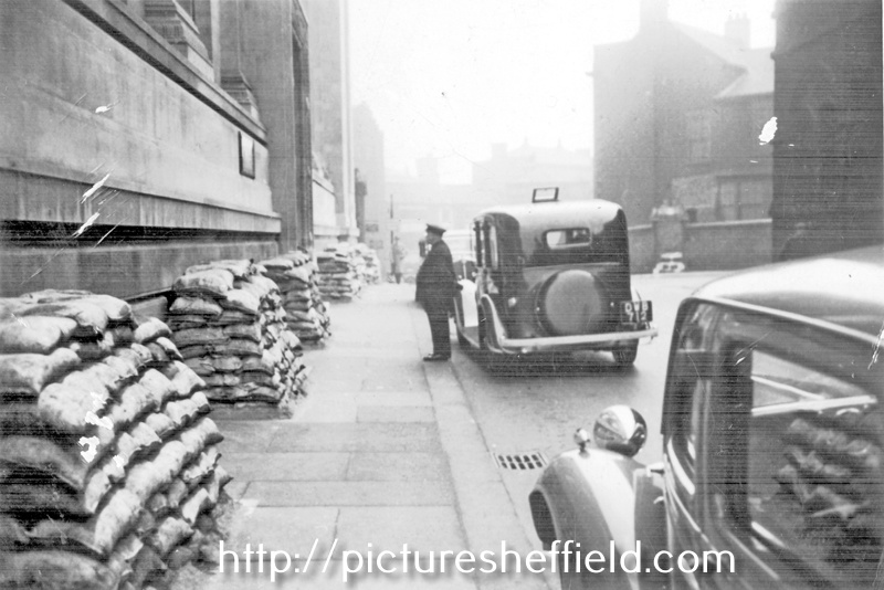 Surrey Street, World War II, sandbags outside Central Library. Leader House, right with chauffer T. Walter Hall standing by the car