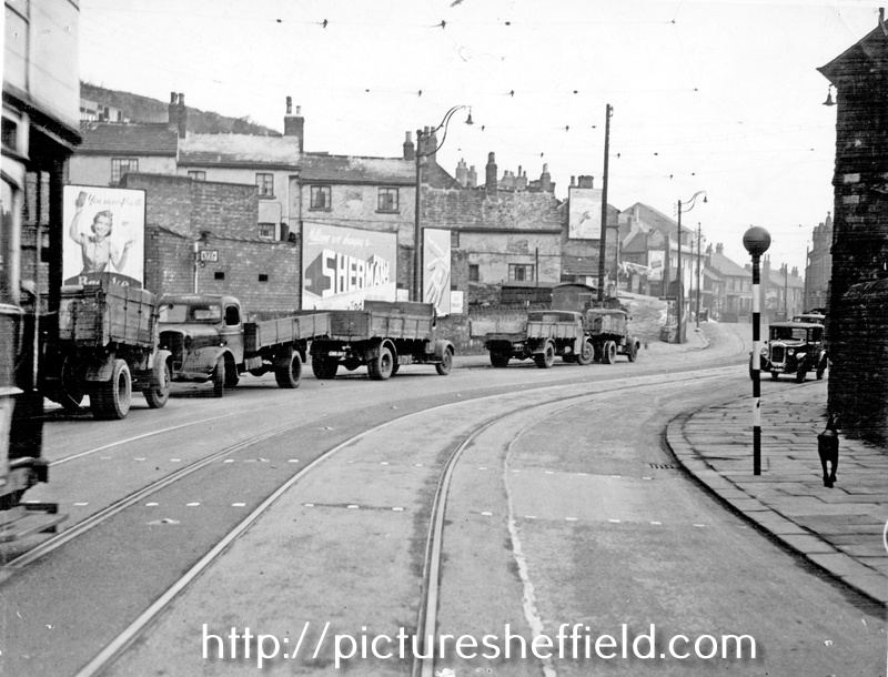 Looking towards the yard of James Cottam, haulage contractor, Upwell Street, Grimesthorpe with Colver's Yard behind the advertising hordings