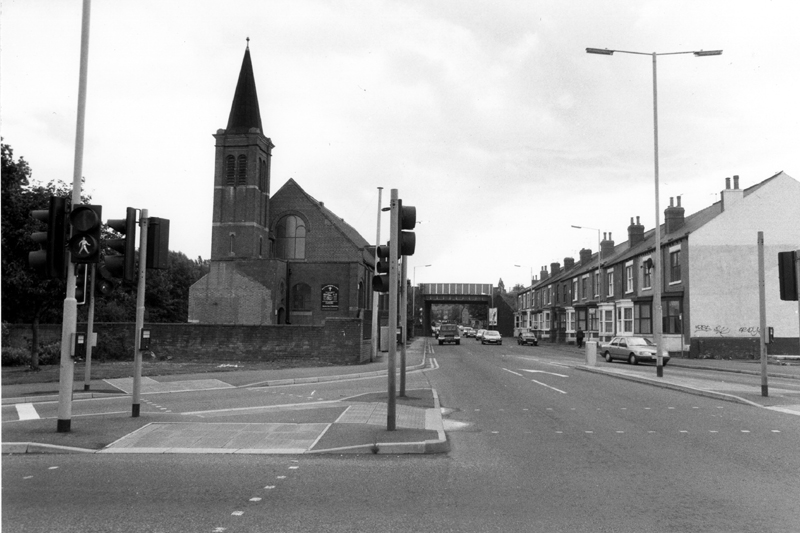 Nos. 833-803 (right) and Church of Jesus Christ Apostolic Incorporated (Pentecostal), formerly Darnall Congregational Church, Prince of Wales Road from the junction of Main Road looking towards Prince of Wales Road Railway Bridge