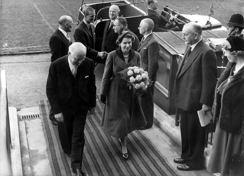 Queen Elizabeth II and HRH Duke of Edinburgh accompanied by Alderman A. Ballard, chairman of the Sheffield Education Committee leaving Hillsborough football ground after the childrens display during their royal visit  