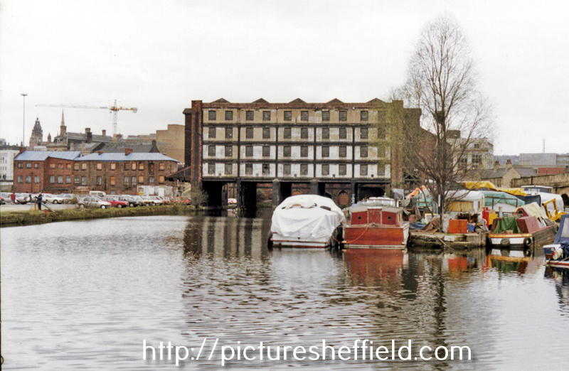 Various water transport in front of the derelict Straddle Warehouse, Canal Basin