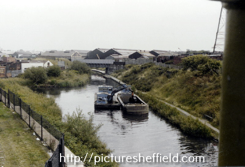 Dredging of the Sheffield and South Yorkshire Navigation viewed from Shirland Lane Bridge looking towards the Railway Bridge over the Canal  and Darnall Works in the background