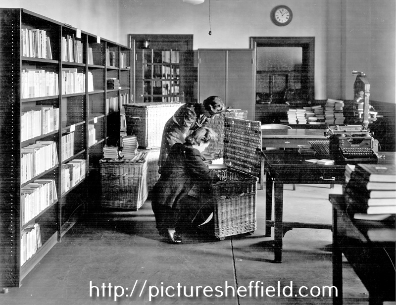 Central Library, Surrey Street. Book Stocks and Cataloguing Department, Miss Jones and Miss Martin pack skips ready for delivery to the Branches