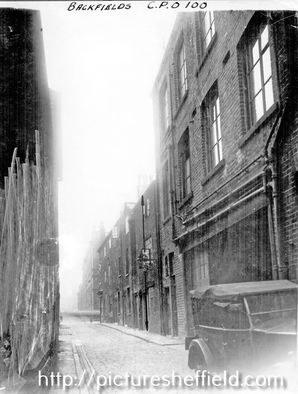 Backfields looking towards Division Street. Former premises of No. 5, William Wilson and Son, Carriage Works, right, in foreground. Entrance to Court No. 2 in background, at gas lamp