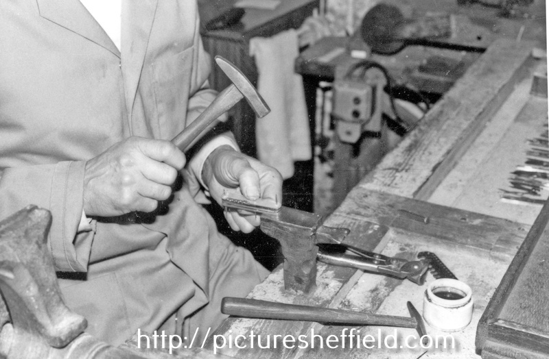 Stan Shaw, cutler, 48 Garden Street, rivetting a Pearl Pocket Knife on his stiddy