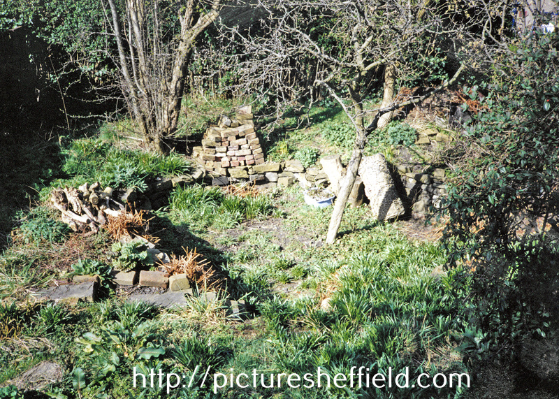 View of garden showing remains of crater made by a German bomb dropped on the night of 12/13th December 1940 at the bottom of the garden of 76 Crawford Road, Norton Lees
