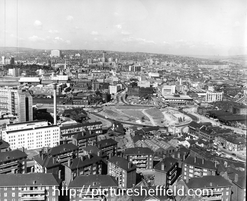Elevated view looking towards the City Centre of Park Square roundabout under construction with Park Hill Flats in the foreground 