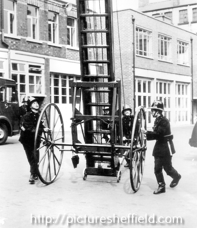 Drilling with a wheeled escape ladder in Division Street Fire Station yard, early 1960s