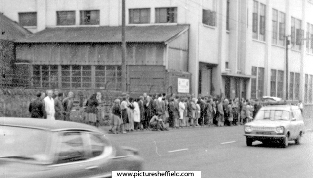 Crowds gathering outside Osborn Mushet tools on Penistone Road, awaiting the visit of the Queen Elizabeth II to open the new stand at Sheffield Wednesday Football Ground