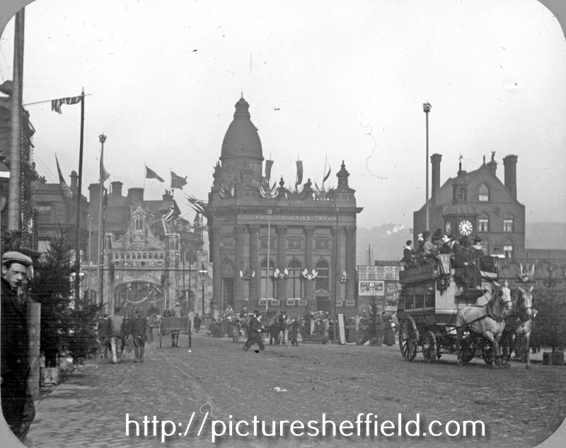 High Street looking towards Commercial Street showing decorations for the royal visit of Queen Victoria. Fitzalan Square, right, Birmingham District and Counties Banking Co. Ltd., centre