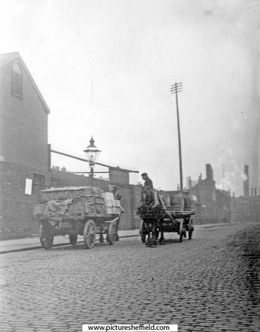 Horse drawn carts on unidentified street