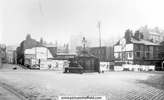 Barkers Pool looking towards Holly Street, left, and the 'Iron Man', from Cambridge Street, prior to the construction of the City Hall. Advertising hoardings are on the site of demolished Pool Place and buildings at Balm Green can be seen in the back
