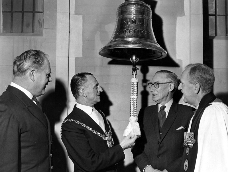 Former Captain A.W. Clarke hands over the Ships Bell of the Southampton Class Cruiser, HMS Sheffield to Lord Mayor Harold Lambert and the Very Rev. Ivan D. Neil, Provost of the Cathedral for safe keeping