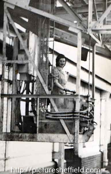 Doris Coyne (nee Speight) at her gantry crane operating station during World War Two, Samuel Fox and Company Limited, Stocksbridge, c. 1944/5