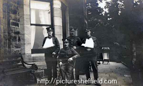 Group of four wounded First World War soldiers outside Lady Bower House, where they were presumably convalescing, c. 1915