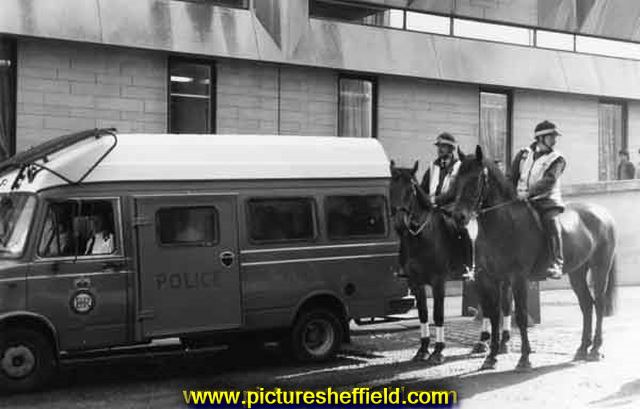 Police van and police horses on duty outside the Town Hall extension, Norfolk Street, during the day of action by Council workers against proposed cuts
