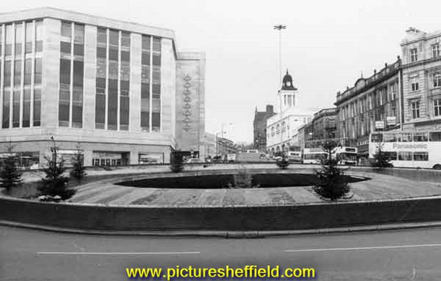 Castle Square (Hole in the Road) roundabout with Christmas trees showing Rackhams, department store (left)