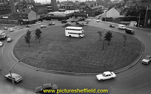 Brook Hill roundabout with double decker bus in the centre of the roundabout