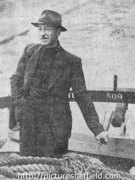 John Hunt, skipper of the M.V. Ready at the tiller, Sheffield Canal Basin