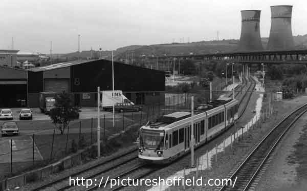 Supertram No.11 at Meadowhall showing Tinsley Cooling Towers and Viaduct (right)