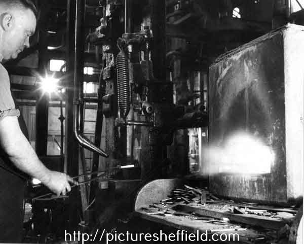 Bob Willerton stamping out a blade under a power hammer in the forging shop, Joseph Rodgers and Sons Ltd. River Lane Works at the junction of Sheaf Street and Pond Hill