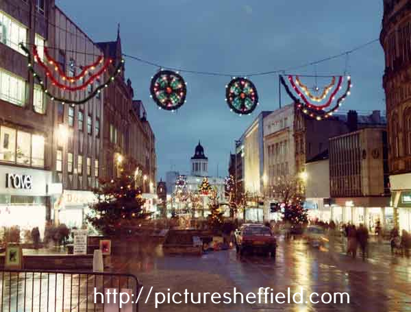 Christmas decorations on Fargate showing (left) Ravel shoe shop