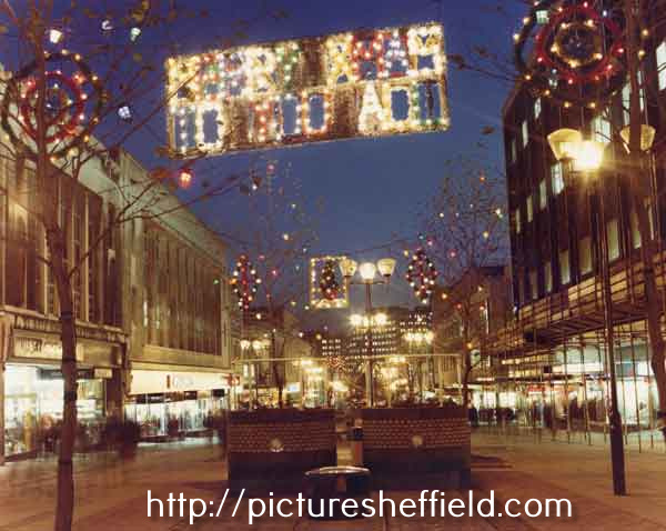Christmas decorations on The Moor showing (left) Nos. 6-7 Quadrant stationers and Nos. 15-19 F.W.Woolworth and Co. Ltd., department store