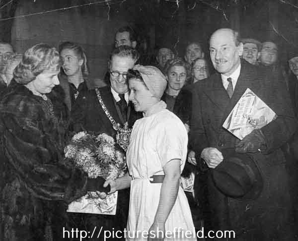 Buffer girl, Ethel Jones (nee Spotswood), from Walker and Hall Ltd., presenting flowers to Clement Atlee's wife (first left) at the City Hall showing Clement Attlee (first right) and the Lord Mayor, Alderman William Ernest Yorke (centre)