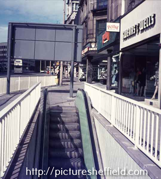 Escalator on High Street to subway showing (right) No.41, Polly of Picacadilly, costumiers and No.43 Swears and Wells Ltd., furnishers