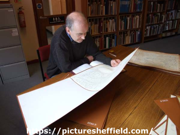 Archives Assistant, Graeme Siddall, viewing a manuscript, Sheffield City Archives, No. 52 Shoreham Street