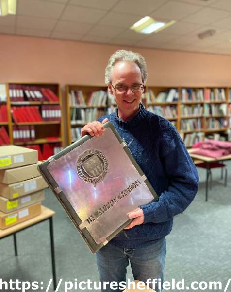 Archivist Robin Wiltshire with a stainless steel volume newly acquired by Sheffield City Archives