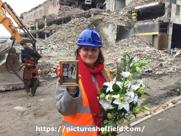 Sheffield City Council Leader, Julie Dore, outside the demolished Grosvenor House Hotel holding a photograph of her wedding (the reception had been held at the hotel)