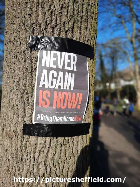 Poster in Endcliffe Park: Never again is Now! #Bring Them Home Now.