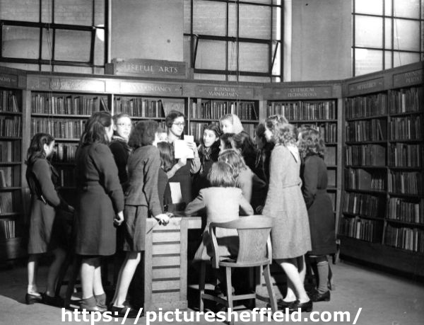Miss Charlesworth with a group of girls in the Central Library during school instruction