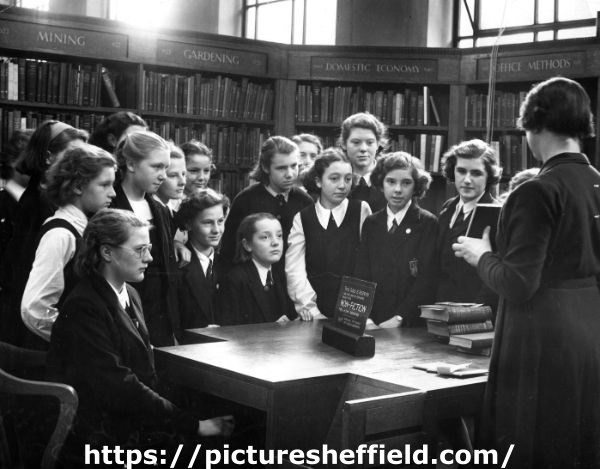 Miss Charlesworth with a group of girls in the Central Lending Library, Central Library during school instruction