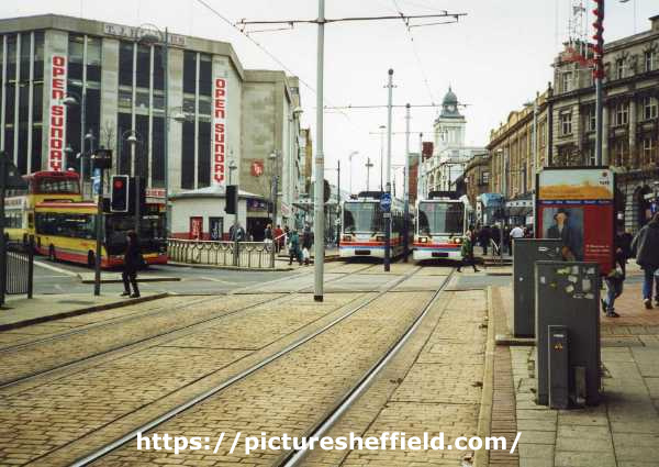 View from Commercial Street of Supertrams at Castle Square Supertram stop showing (left) T. J. Hughes, department store, High Street